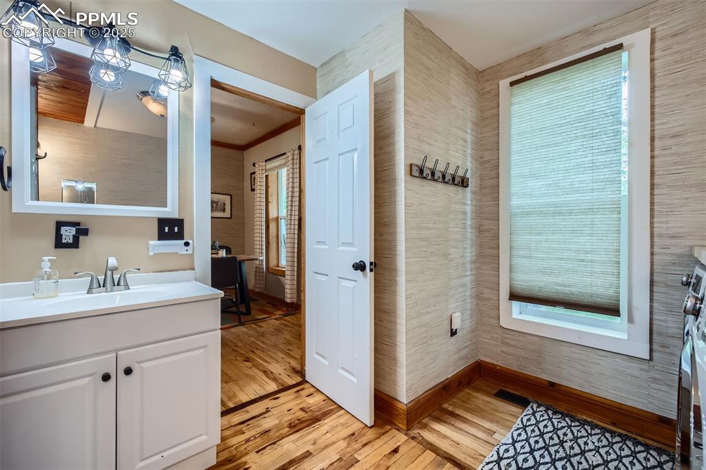 Image 9 of 20: Bathroom featuring wood finished floors, vanity, and baseboards