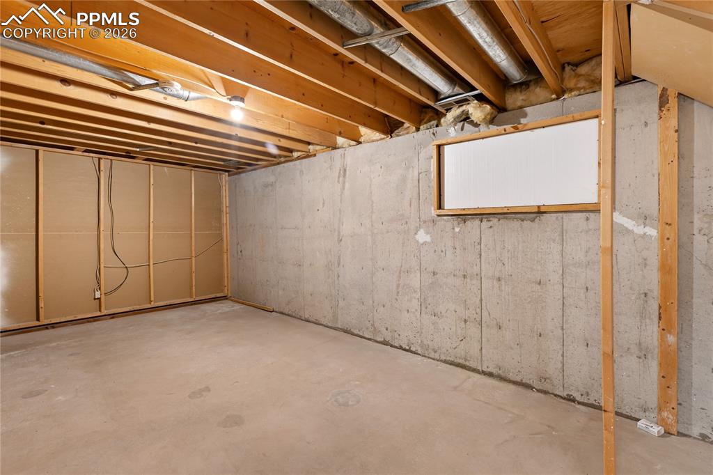 Image 37 of 42: Unfinished basement space with egress window - potential for 4th bedroom