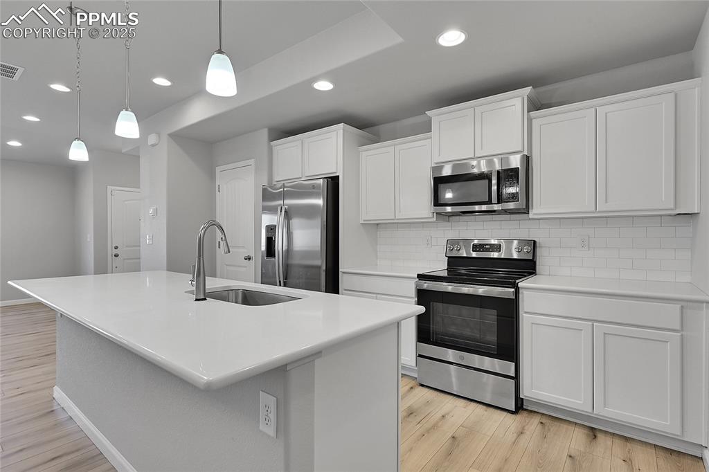 Image 16 of 46: Kitchen featuring appliances with stainless steel finishes, tasteful backsp