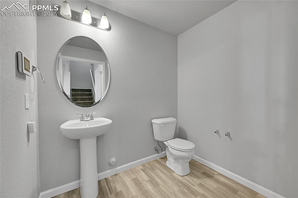 Image 18 of 46: Bathroom featuring light wood finished floors and a textured wall