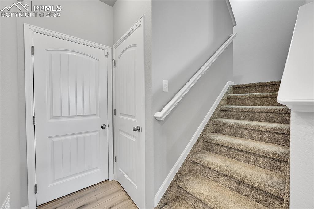 Image 19 of 46: Stairs with wood finished floors and baseboards