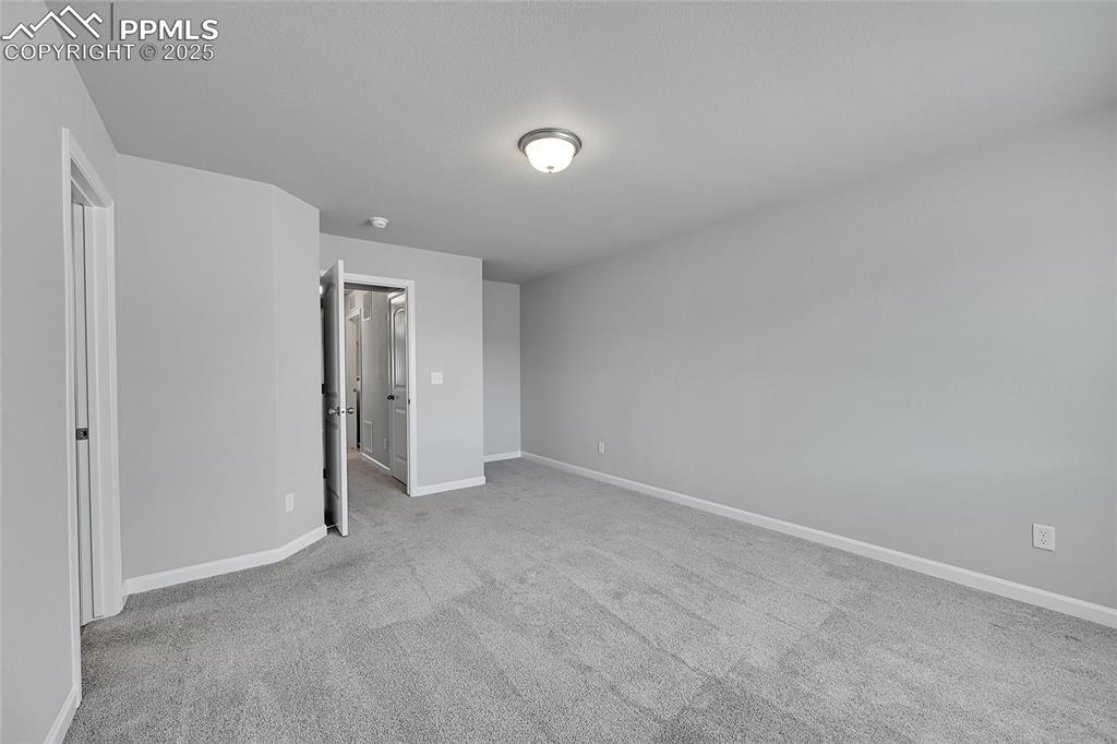 Image 25 of 46: Unfurnished bedroom with baseboards and light colored carpet