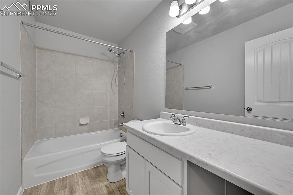 Image 32 of 46: Full bathroom with light wood-style floors, tub / shower combination, and v