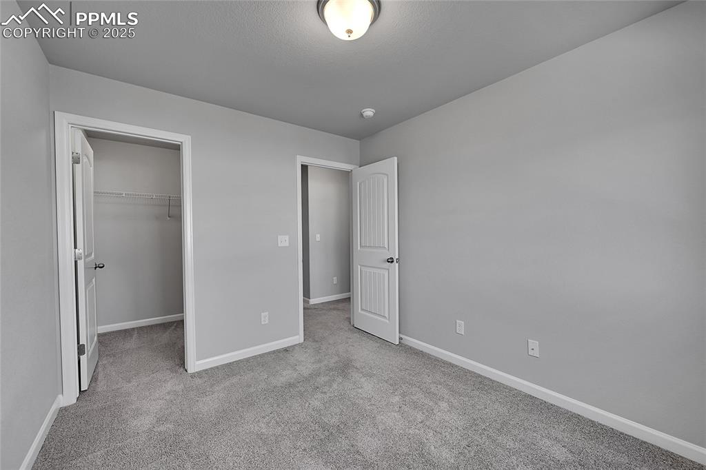 Image 34 of 46: Unfurnished bedroom with light colored carpet and a spacious closet