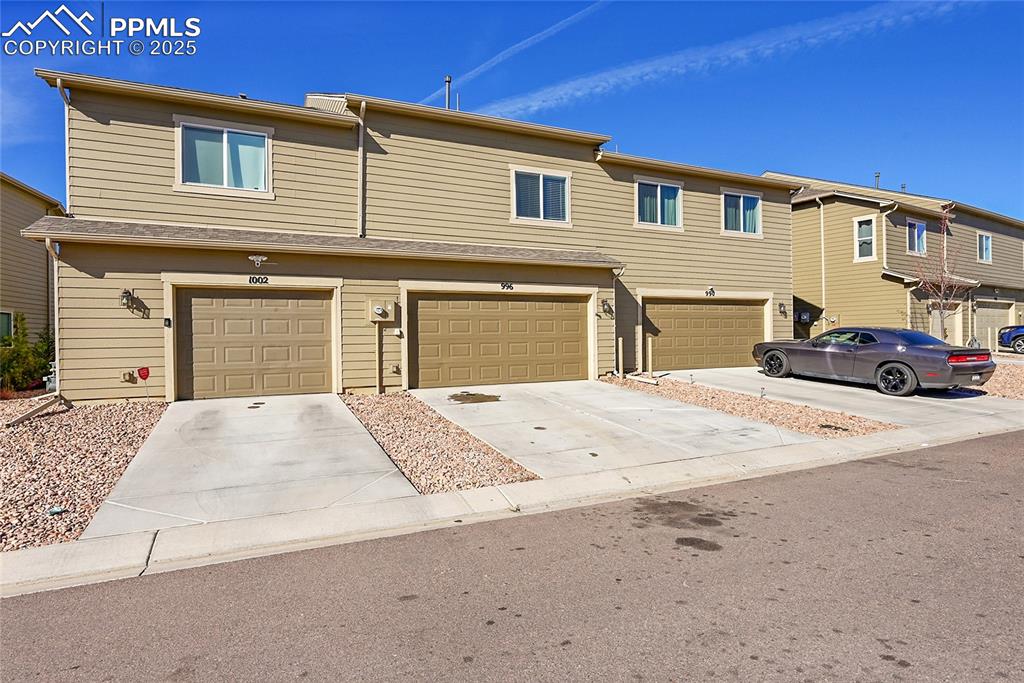 Image 38 of 46: Traditional-style home with concrete driveway