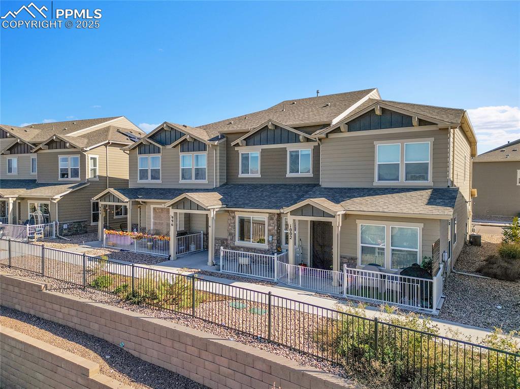 Image 39 of 46: Craftsman house with a fenced backyard, board and batten siding, a shingled