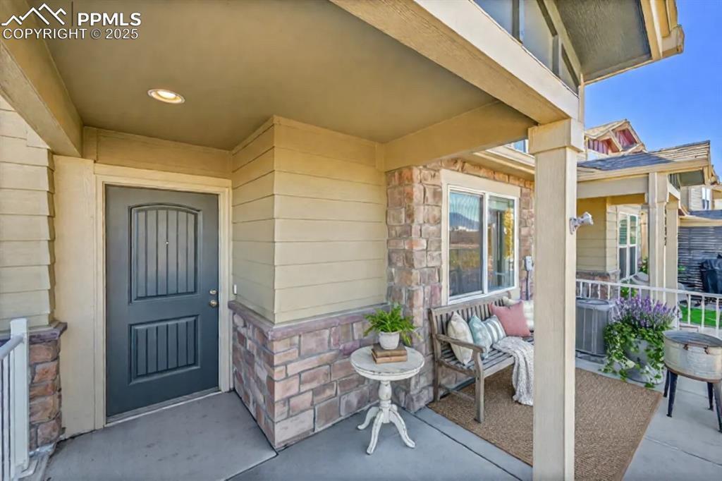 Image 4 of 46: View of exterior entry with stone siding