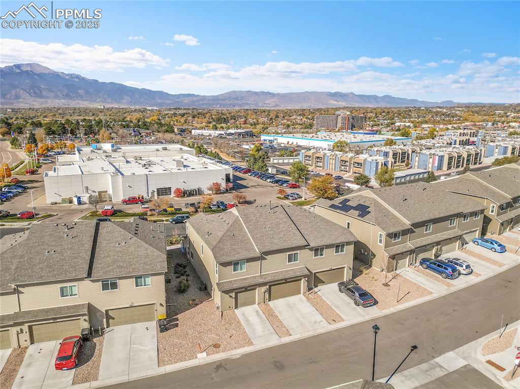 Image 44 of 46: Aerial perspective of suburban area featuring a mountainous background