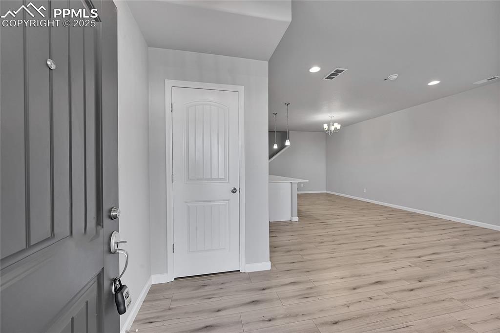 Image 5 of 46: Entryway with recessed lighting, light wood-type flooring, and a chandelier