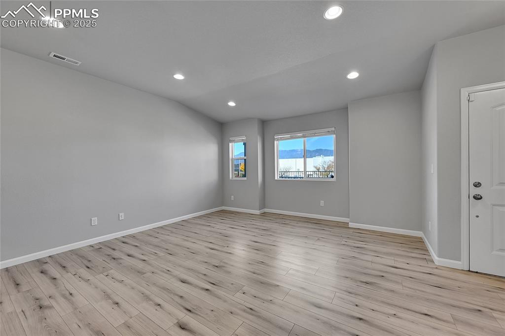 Image 8 of 46: Empty room with recessed lighting and light wood finished floors