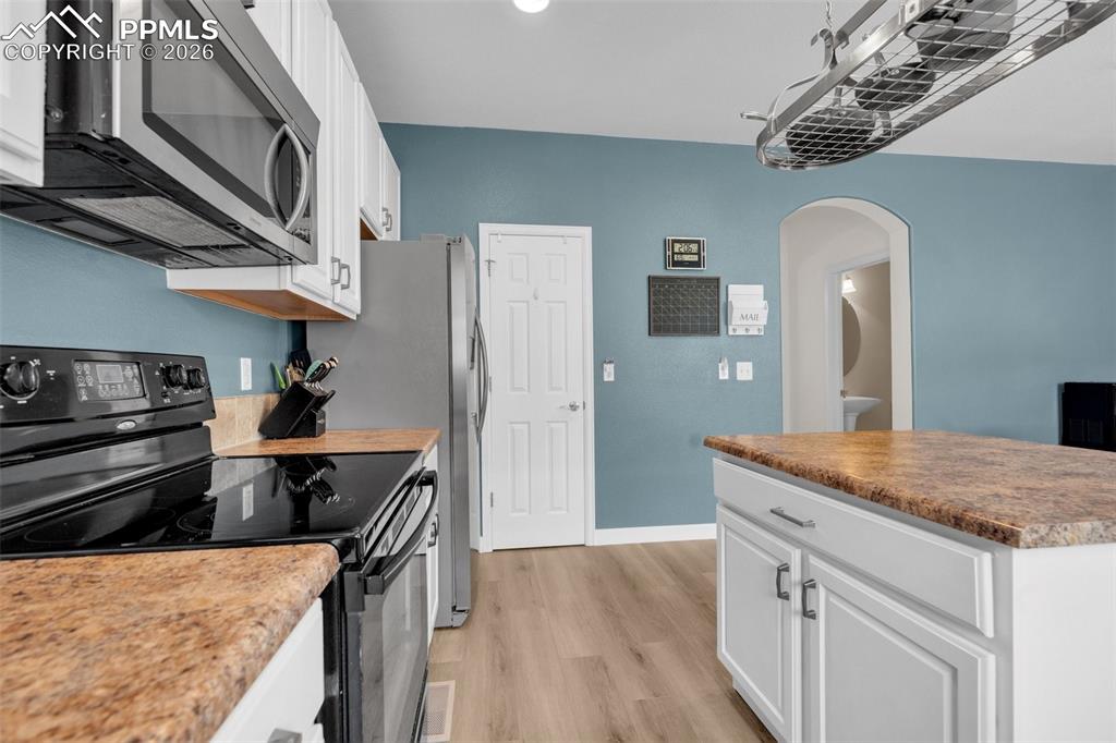 Image 13 of 39: Dining area featuring light wood-style floors and recessed lighting