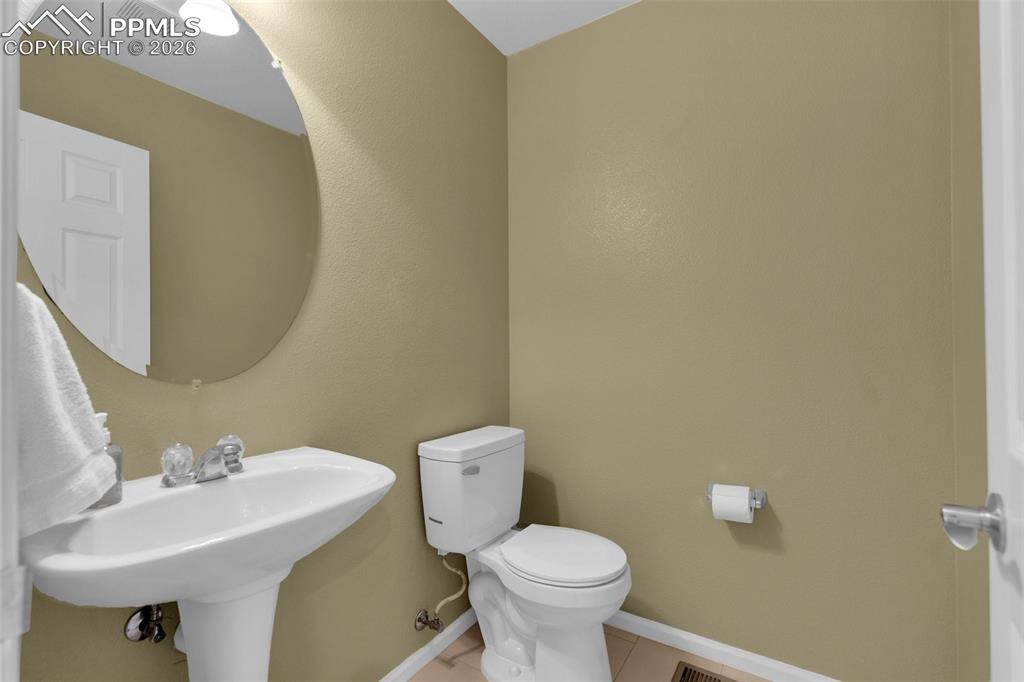 Image 15 of 39: Kitchen with arched walkways, white cabinets, stainless steel appliances, a