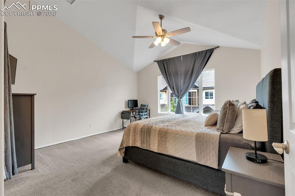 Image 17 of 39: Kitchen with stainless steel appliances, white cabinetry, a breakfast bar, 