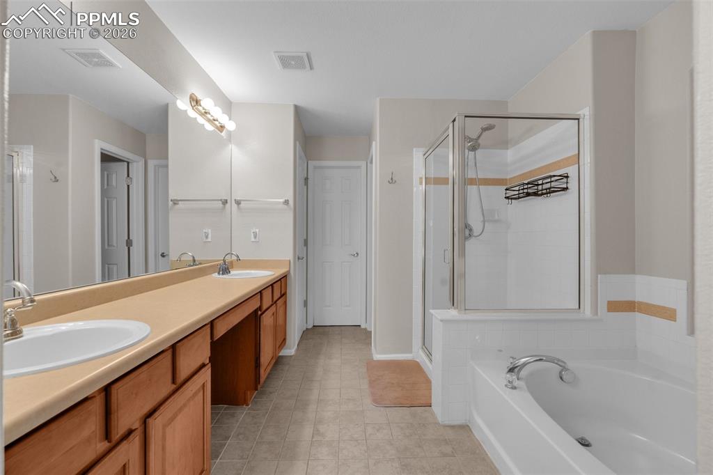 Image 20 of 39: Carpeted bedroom with lofted ceiling and a ceiling fan