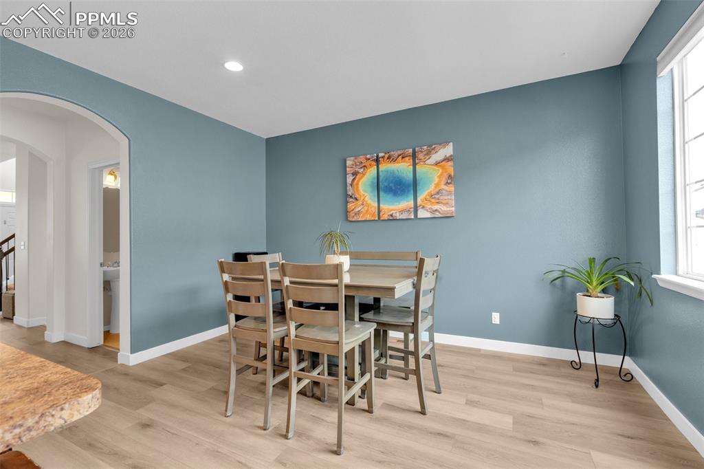 Image 9 of 39: Living room with a ceiling fan and light wood finished floors