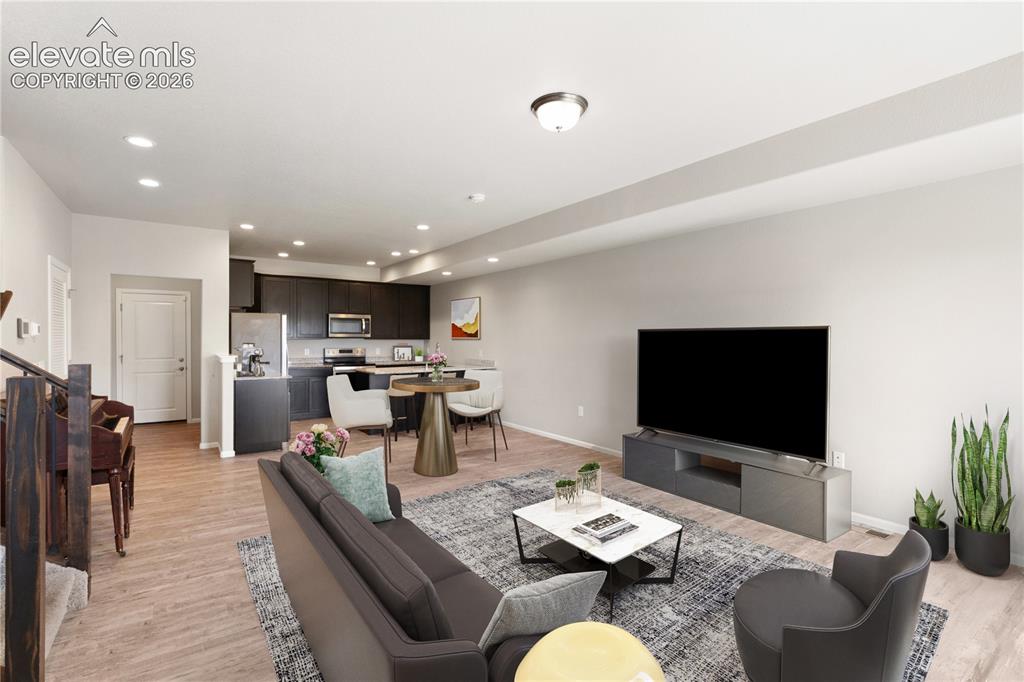 Image 3 of 19: Open concept living area featuring wood-finish flooring, recessed lighting,