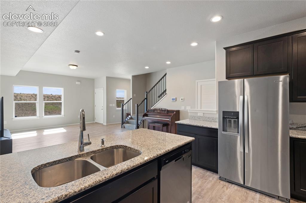 Image 6 of 19: Kitchen island featuring a double basin stainless steel sink with a high-ar
