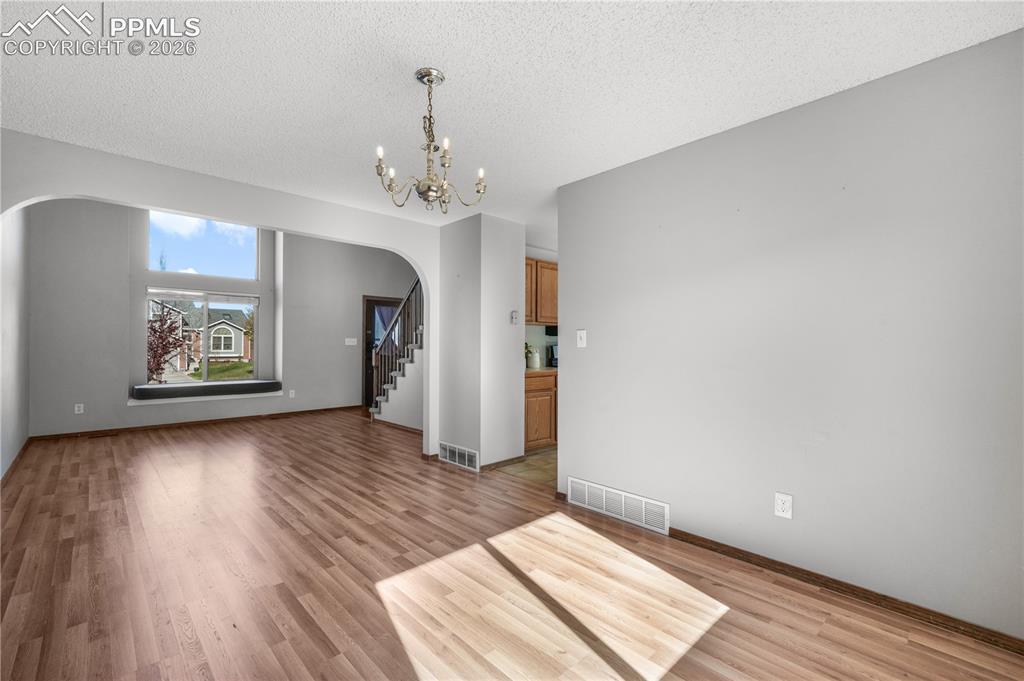 Image 10 of 50: Front entry, formal sitting room and views of dining room