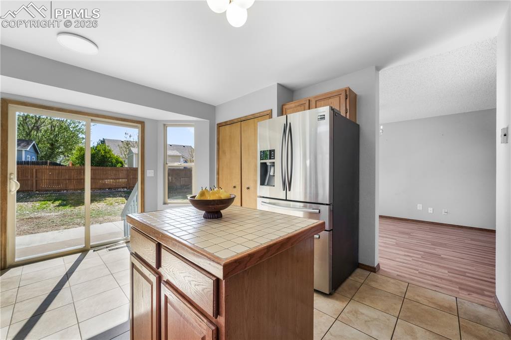 Image 16 of 50: Kitchen with newer stainless steel applicants, island, pantry and walk out
