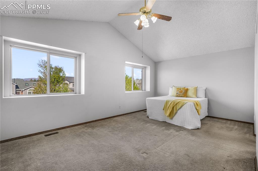 Image 24 of 50: Upstairs primary bedroom with ensuite 5 piece bath and large walk in closet