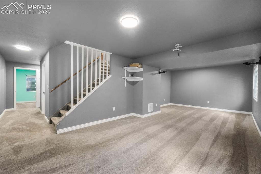 Image 38 of 50: Basement family room/media room with projector