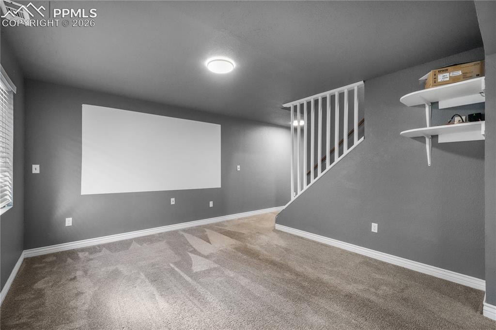 Image 39 of 50: Basement family room/media room with projector