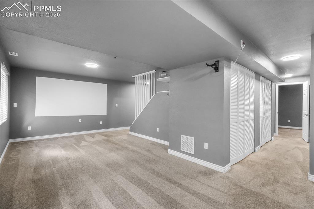 Image 40 of 50: Basement family room/media room with projector