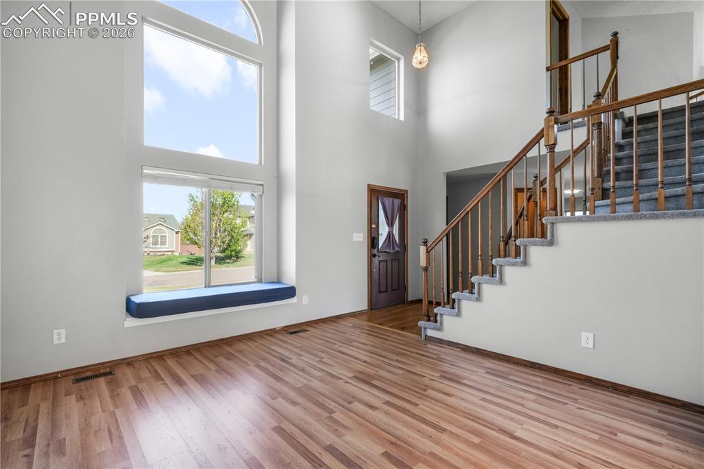 Image 6 of 50: Front entry, formal sitting room and vaulted ceilings with abundant natural