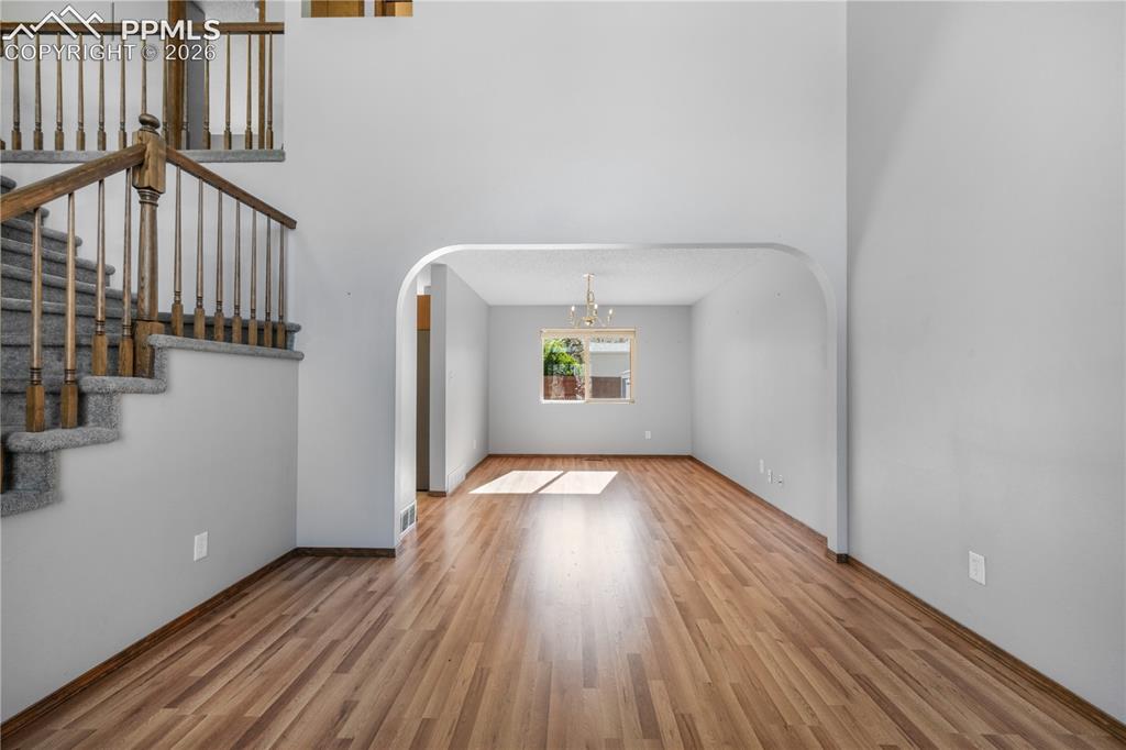 Image 9 of 50: Front entry, formal sitting room and views of dining room