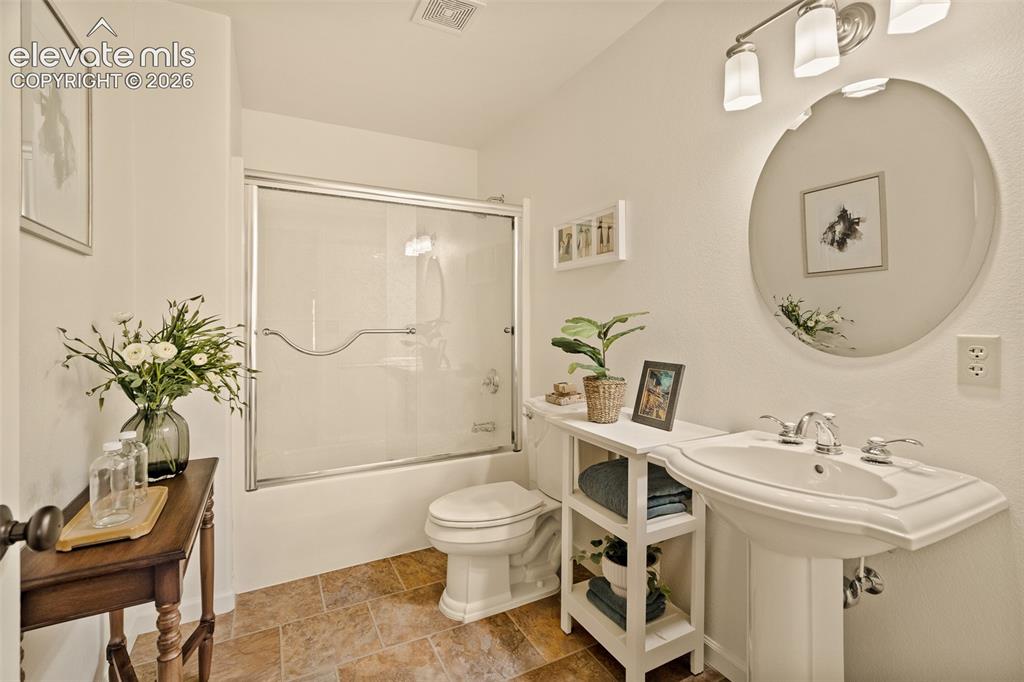 Image 30 of 50: Basement primary bathroom en suite photographed June 2026
