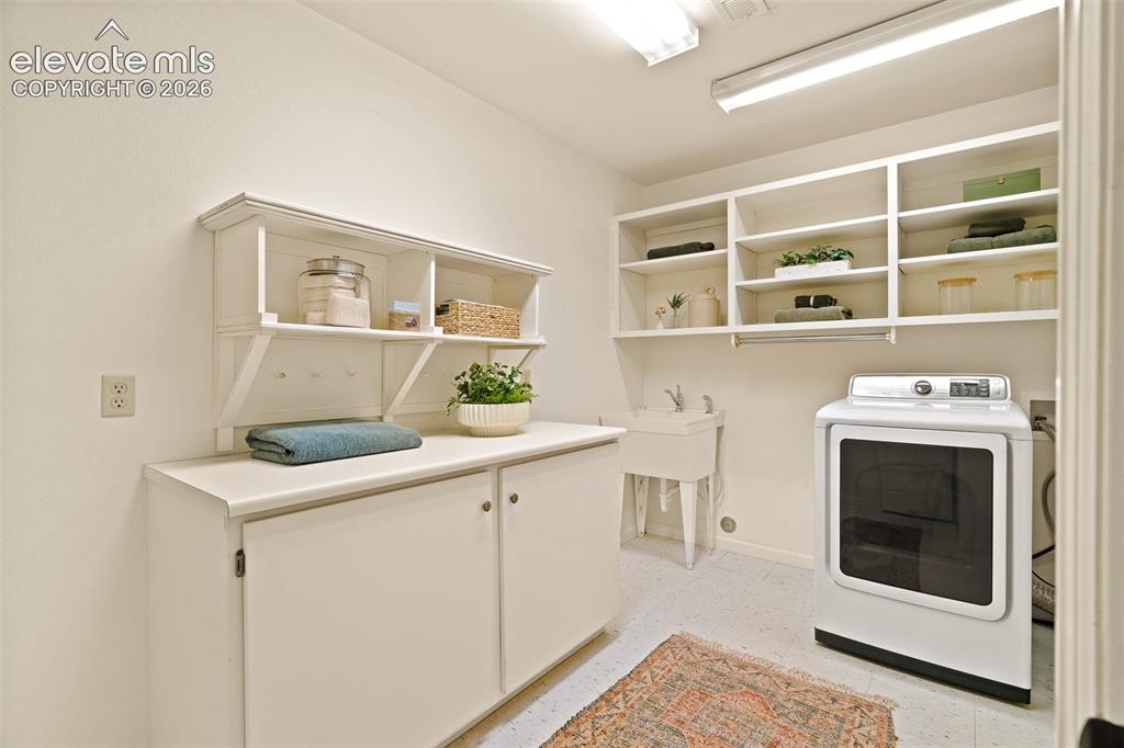 Image 32 of 50: Basement laundry room photographed June 2026