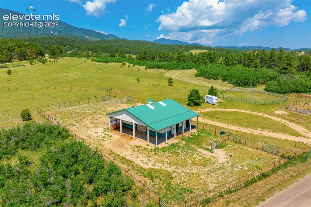 Image 37 of 50: View of stable and pasture photographed June 2026
