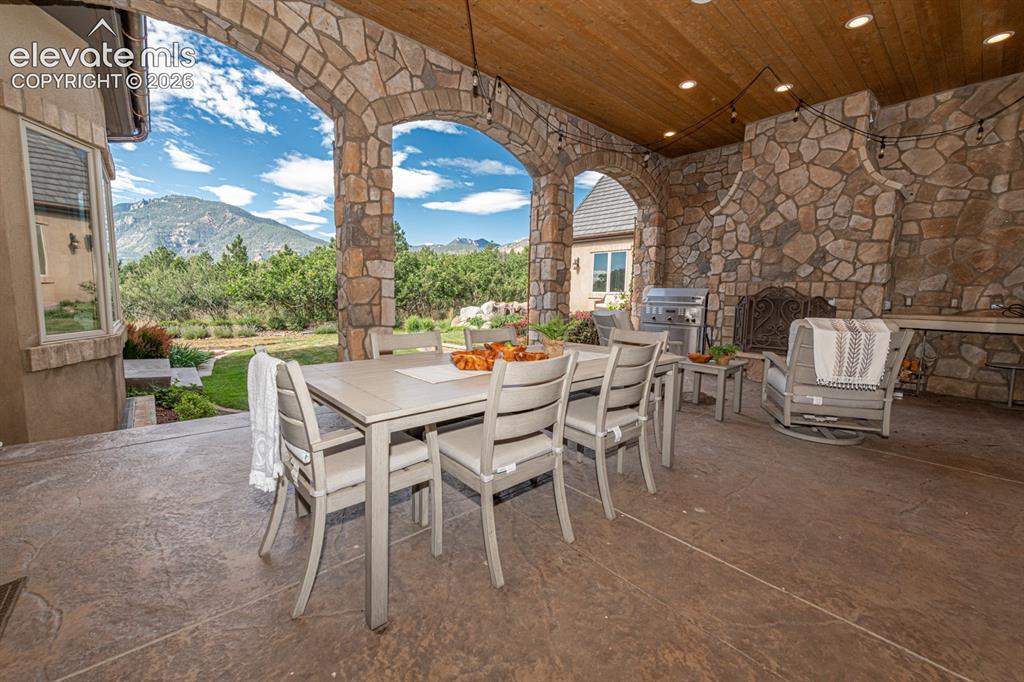 Image 21 of 50: Covered veranda with wood tongue and groove ceilings