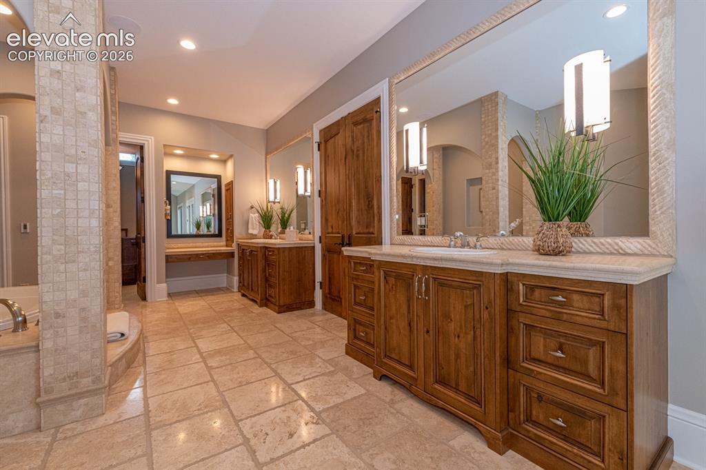 Image 26 of 50: Primary retreat counter space with heated tile floor