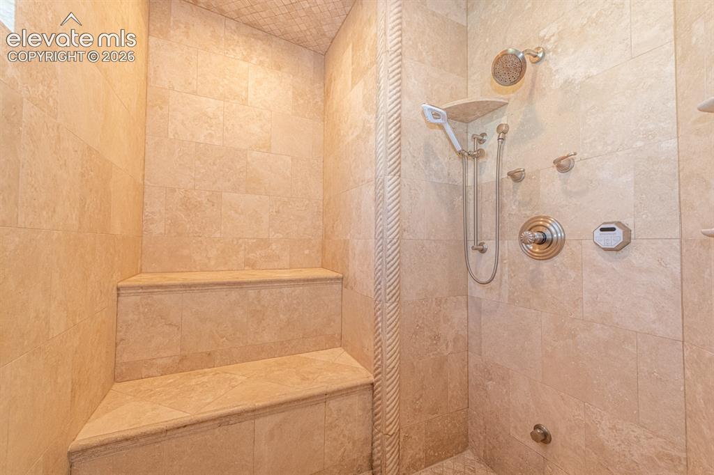 Image 29 of 50: Primary steam shower with bench and dual heads