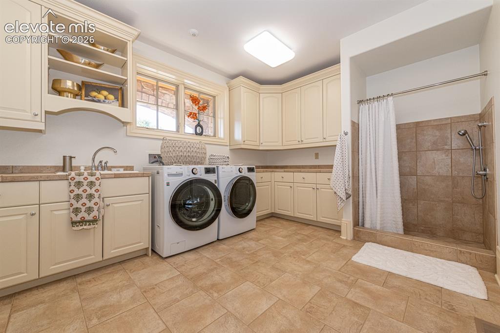 Image 36 of 50: Main level laundry with dog shower