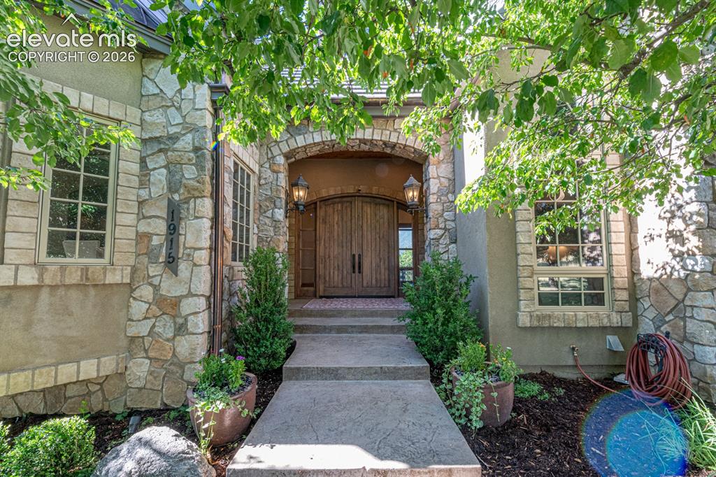 Image 4 of 50: Solid doors and a shaded walkway greet guests