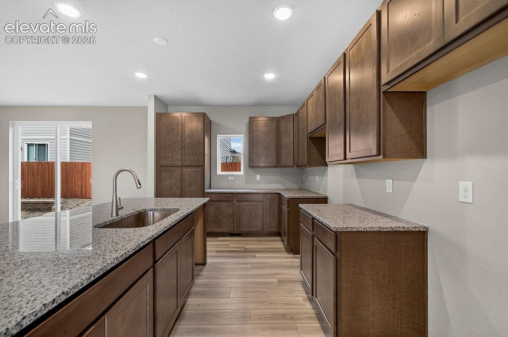 Image 10 of 33: Kitchen featuring recessed lighting, a stainless steel sink with a goosenec