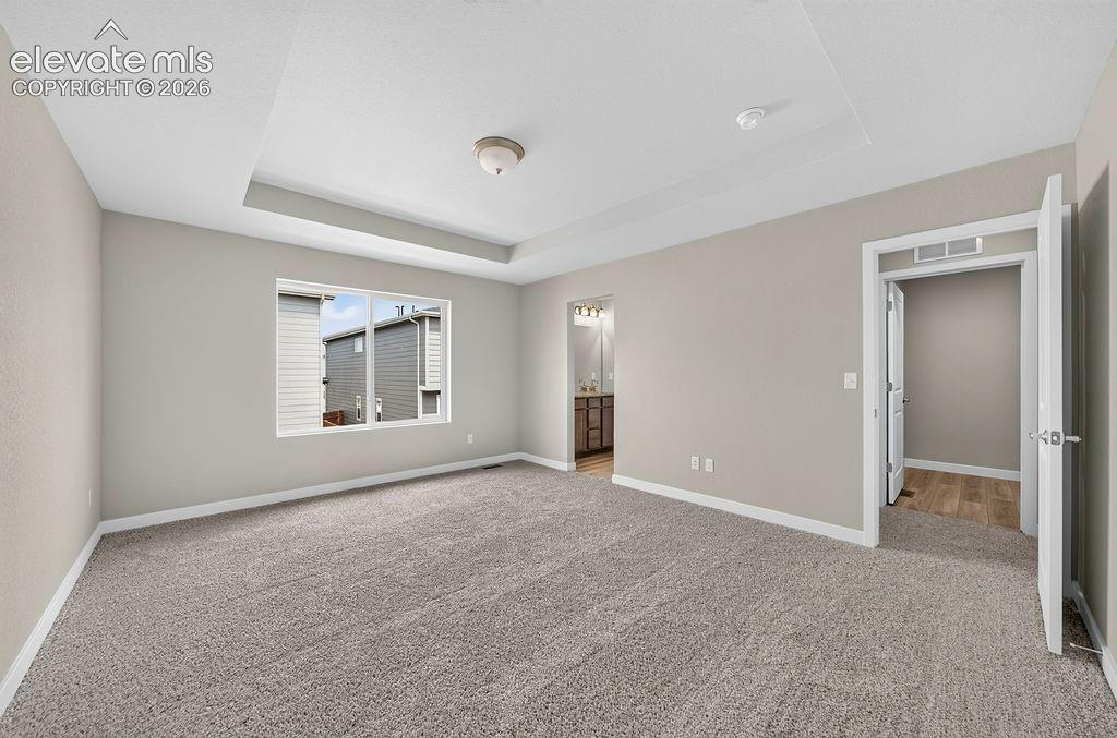 Image 20 of 33: Tray ceiling with recessed lighting