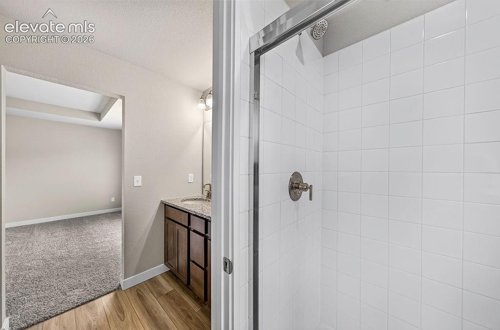 Image 25 of 33: Shower with white subway tile surround, brushed nickel fixtures, and a glas