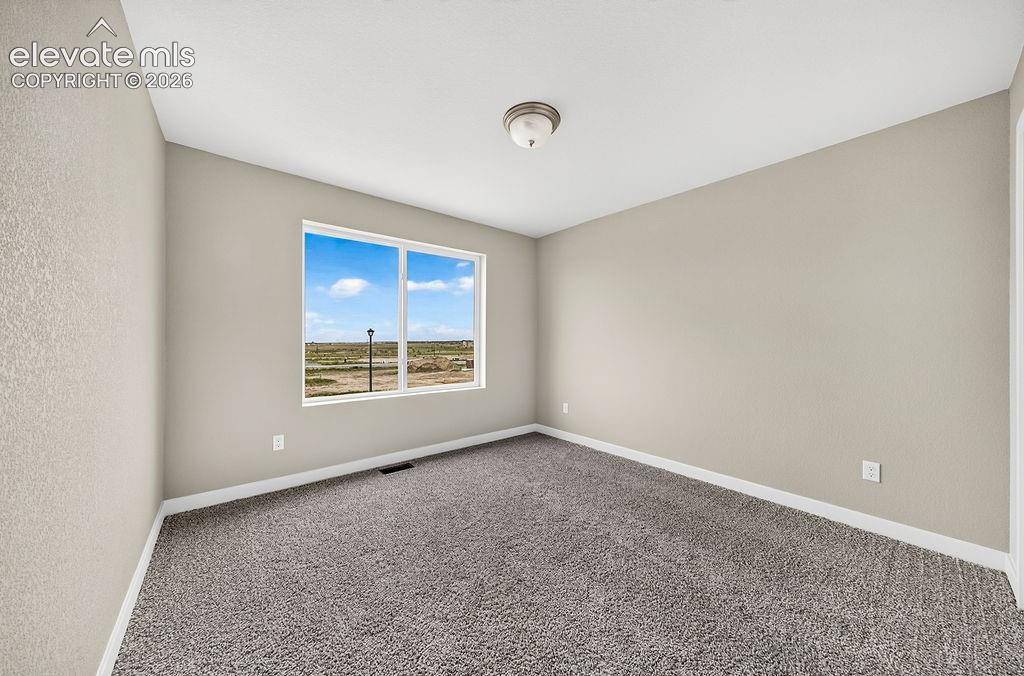 Image 29 of 33: Neutral-toned walls, grey carpeting, and white trim