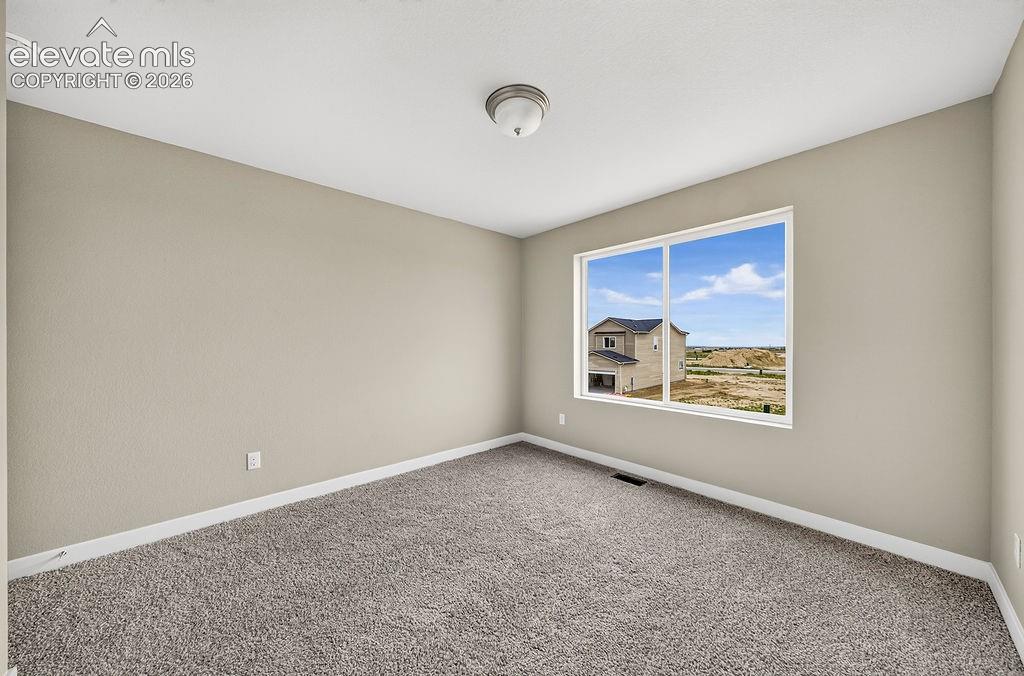 Image 31 of 33: Neutral tone wall finishes, white trim, and a ceiling-mounted light fixture
