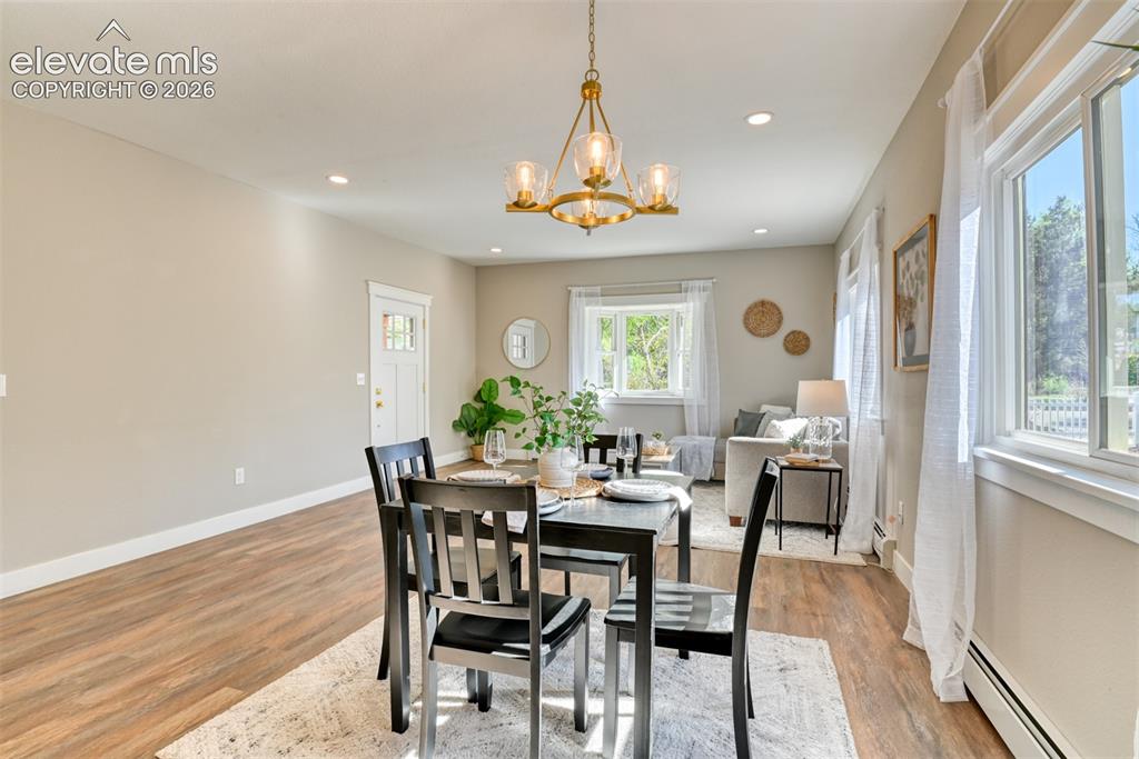 Image 15 of 47: Open-concept living space featuring wood-finish flooring, recessed lighting