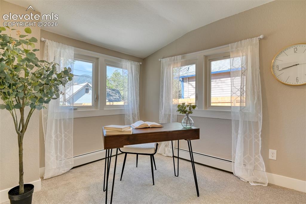 Image 23 of 47: Room featuring a vaulted ceiling and neutral wall tones