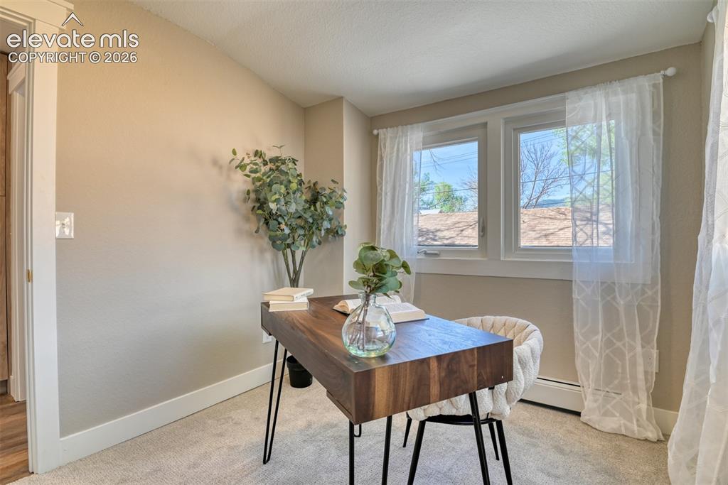 Image 24 of 47: Room featuring neutral wall paint, carpet flooring, white baseboards, and a