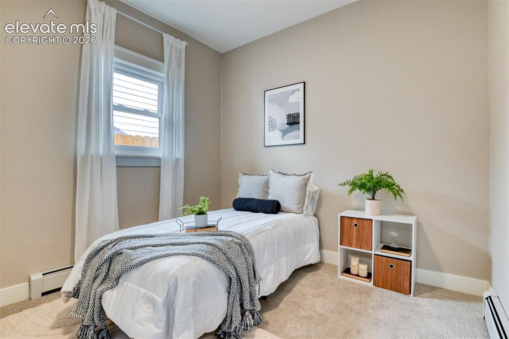 Image 27 of 47: Bedroom featuring neutral-toned walls, white trim, and light-colored carpet