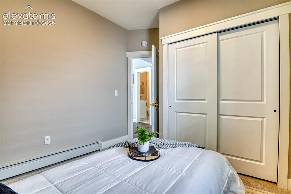Image 29 of 47: Bedroom featuring neutral wall paint, carpet flooring, baseboard heating, a