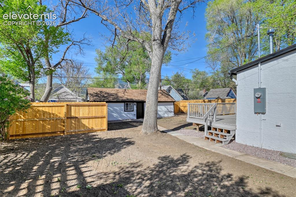 Image 42 of 47: Expansive backyard featuring a new wood privacy fence, a multi-level wood d