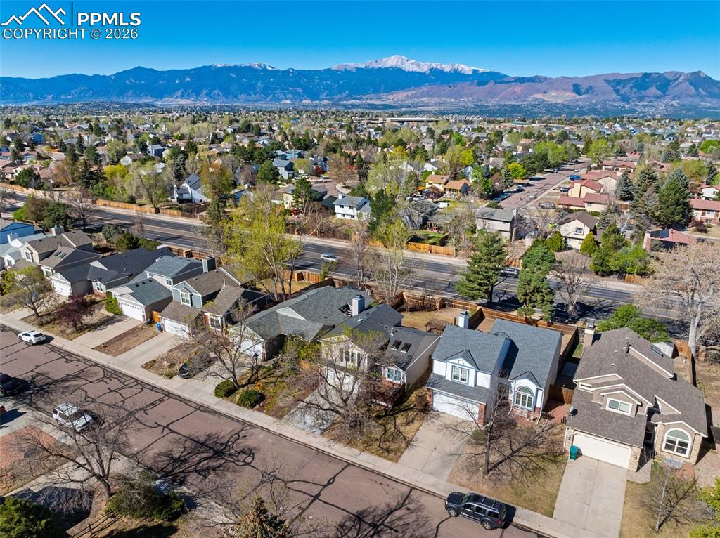 Image 11 of 50: Aerial view of the neighborhood showcasing residential properties with a mo