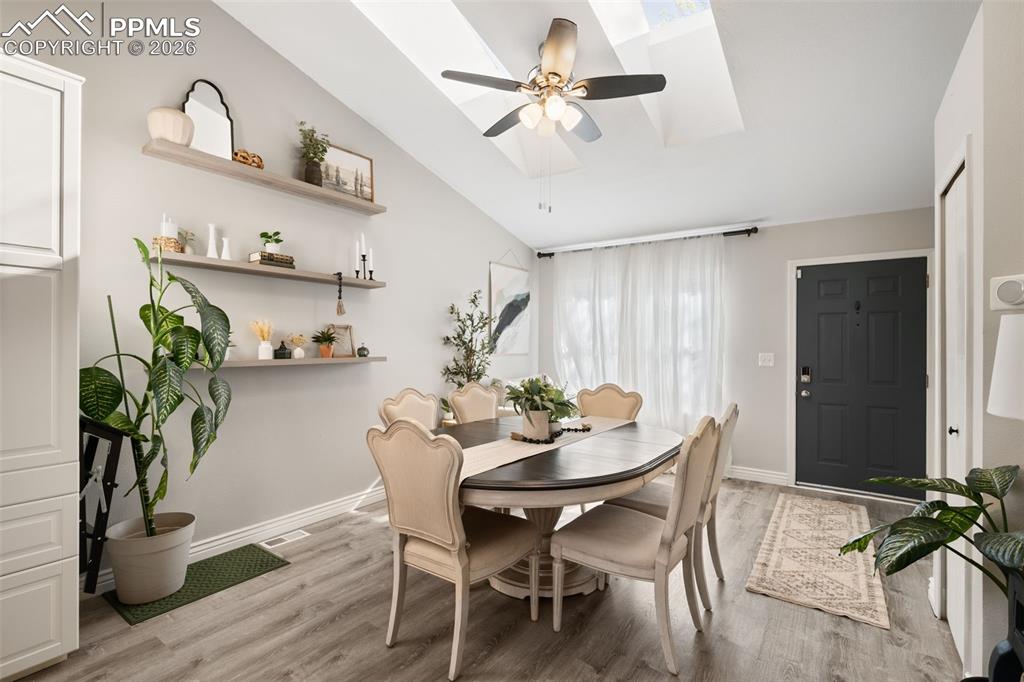 Image 16 of 50: This inviting dining area features vaulted ceilings, a ceiling fan with int